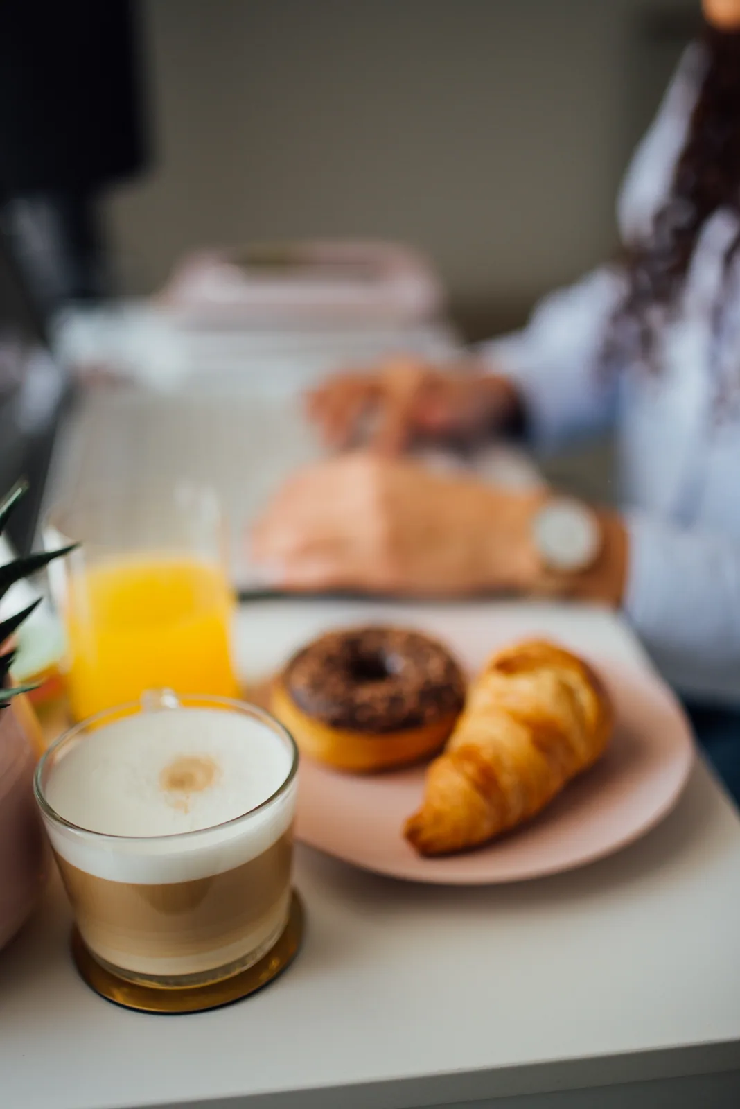 Coffee, pastries, and orange juice arranged for breakfast.