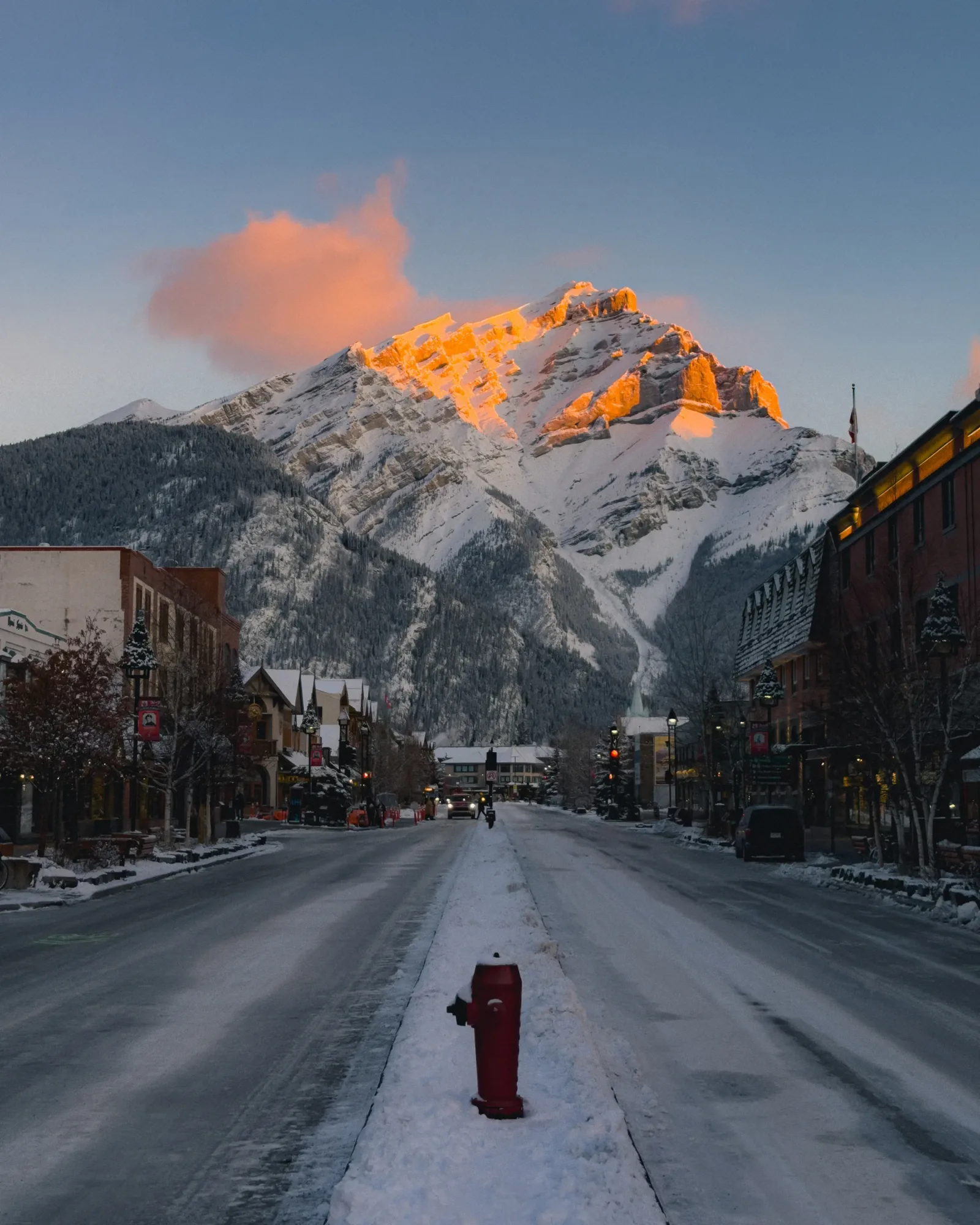 Cascade Mountain rising beyond Banff Avenue at sunset.