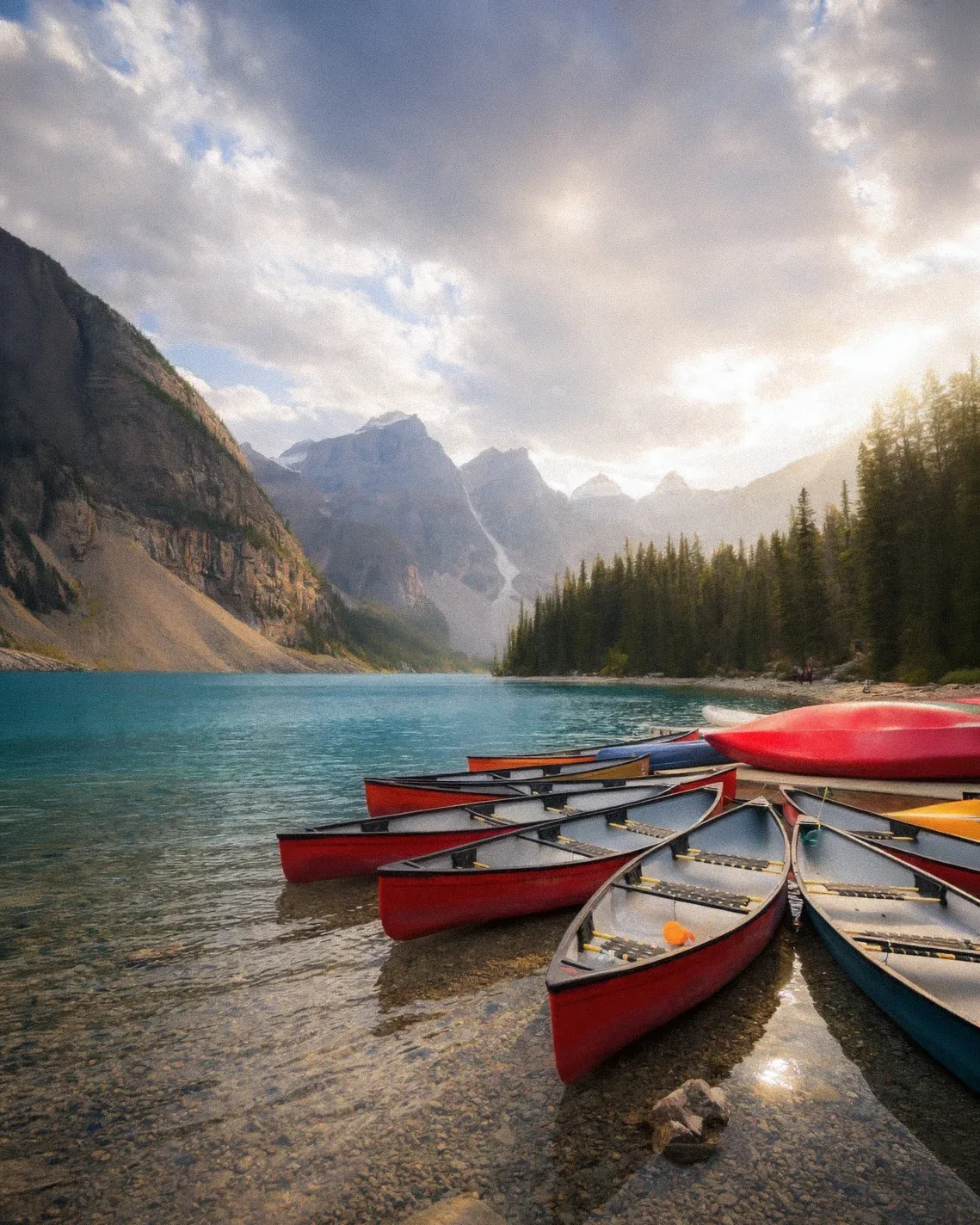 Red canoes lined along the shore of Lake Louise.