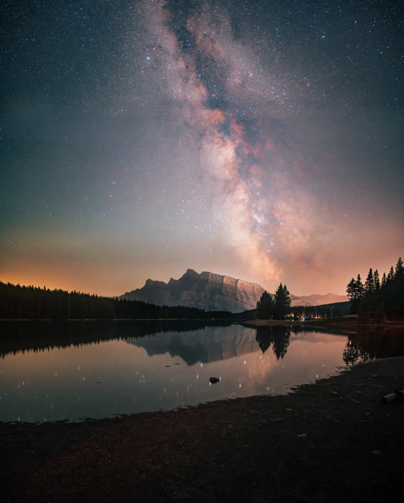 The Milky Way above a dark mountain lake