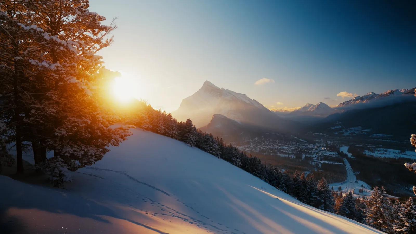 Low winter sun breaking over the Bow Valley near Mount Rundle.